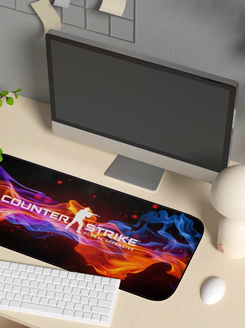 Desk setup with a computer monitor, keyboard, and mouse on a Counter-Strike mouse pad.