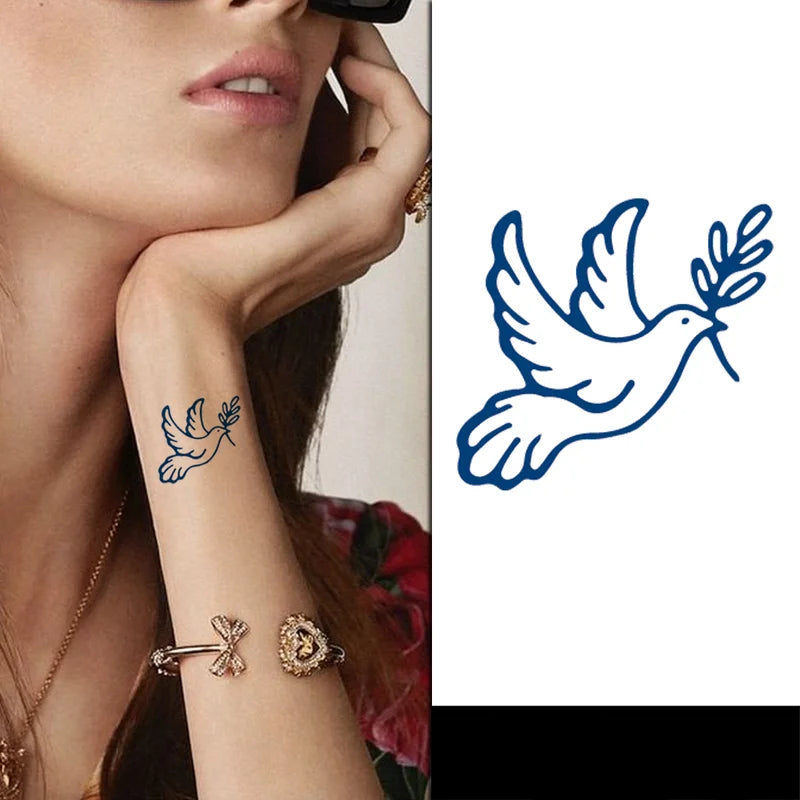 Woman with a blue dove tattoo on her arm, wearing gold jewelry