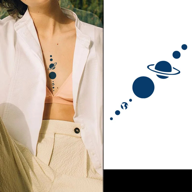 Person wearing a white shirt with a space-themed tattoo