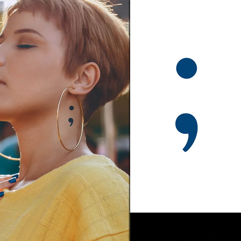 Temporary Tattoo design of a semi colon symbol on a females neck