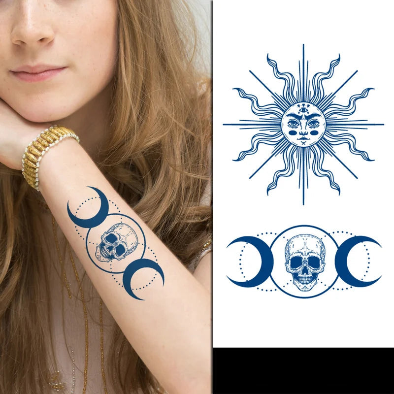 Tattoo design of a sun, moon, and skull on a person's arm with a close-up