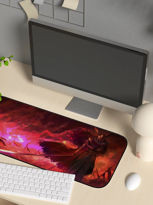 Computer setup with a large mouse pad featuring a fantasy design on a desk.