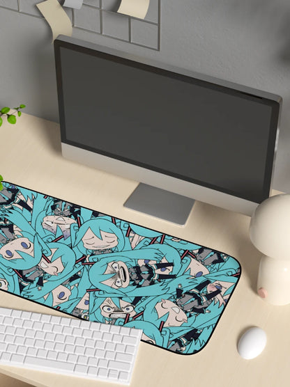 Desk setup with a computer monitor, keyboard, and mouse pad featuring anime characters.