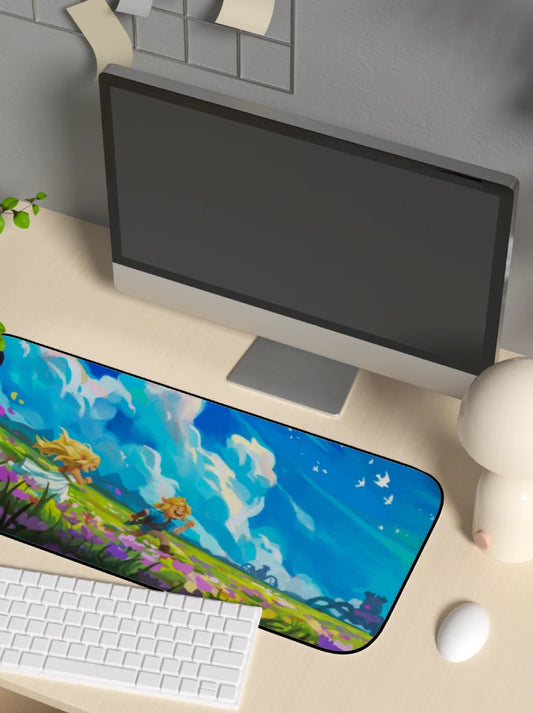 Desk setup with a computer monitor, keyboard, and mouse on a desk with a colorful mouse pad.