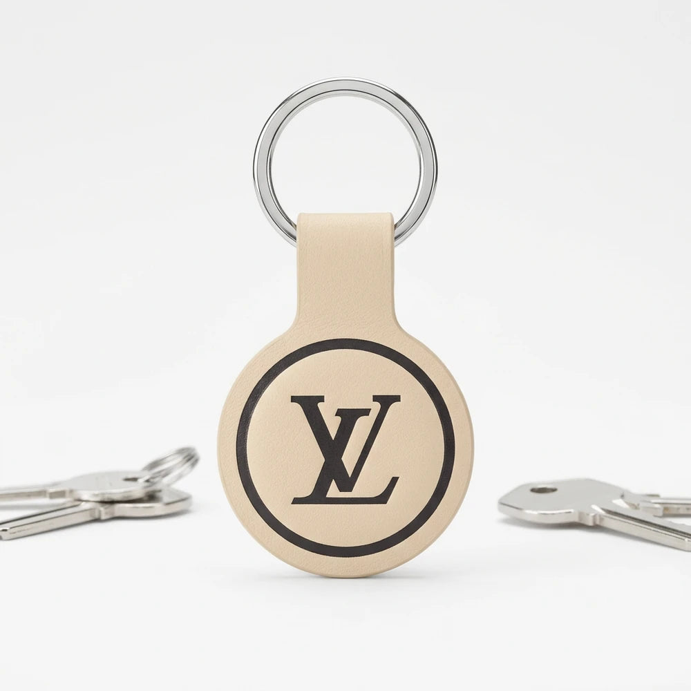 Louis Vuitton keychain with logo on a white background with keys on the floor