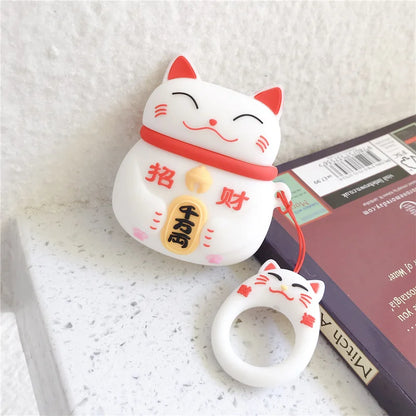 White cat-shaped phone charm with red accents on a white surface