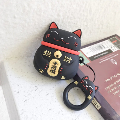 Black cat-shaped air pod case with red accents on a textured surface