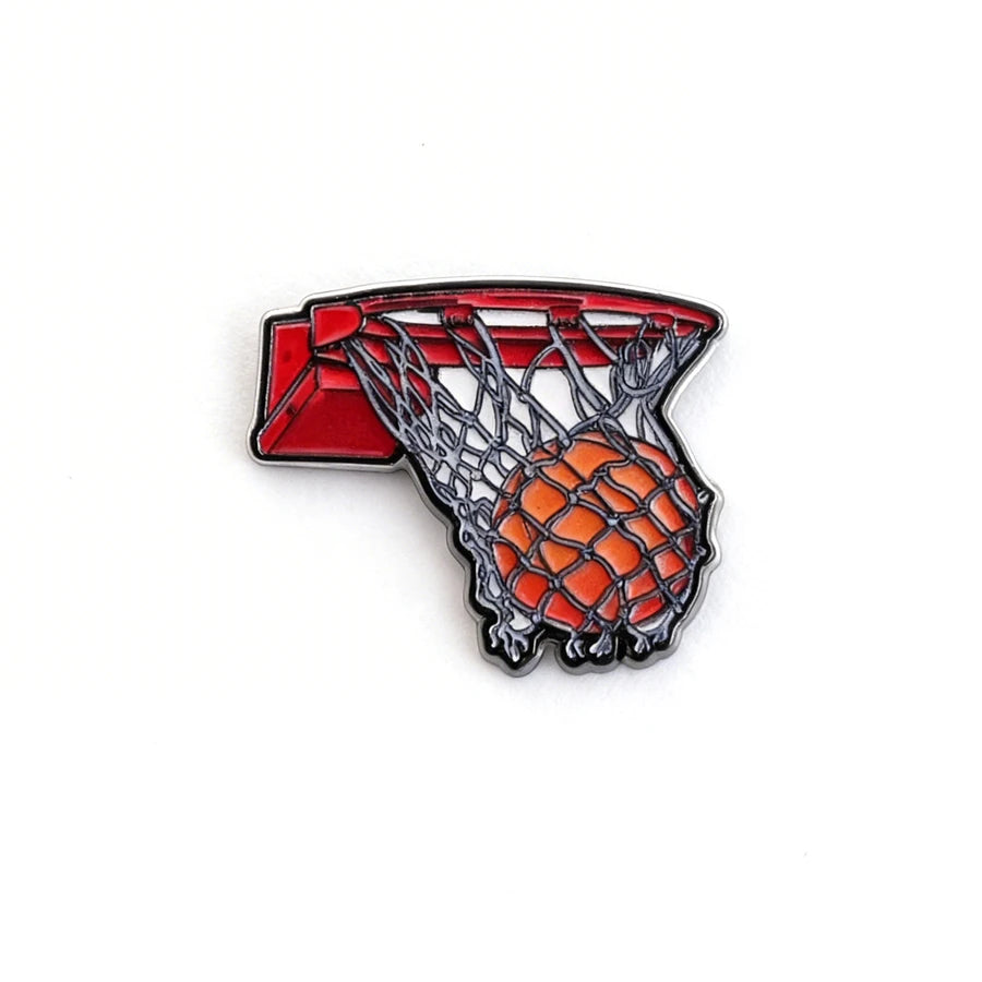 Basketball hoop and ball enamel pin on a white background