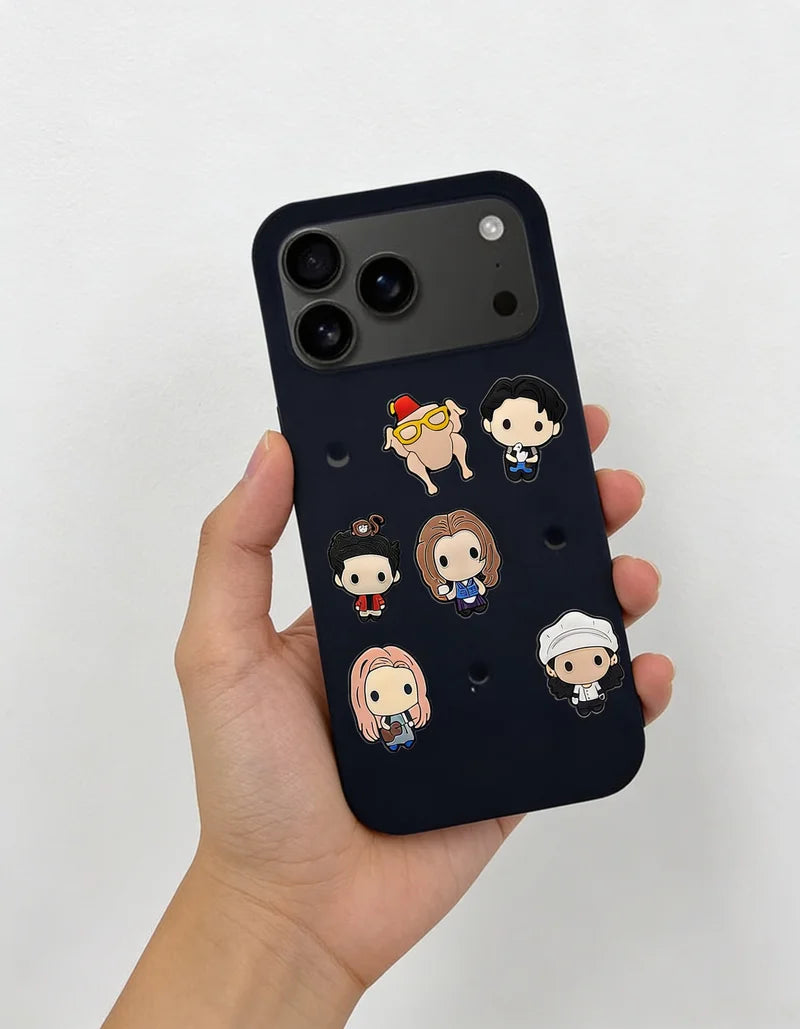 Phone case with cartoon character designs held by a hand on a light gray background