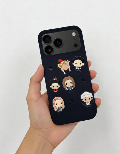 Phone case with cartoon character designs held by a hand on a light gray background