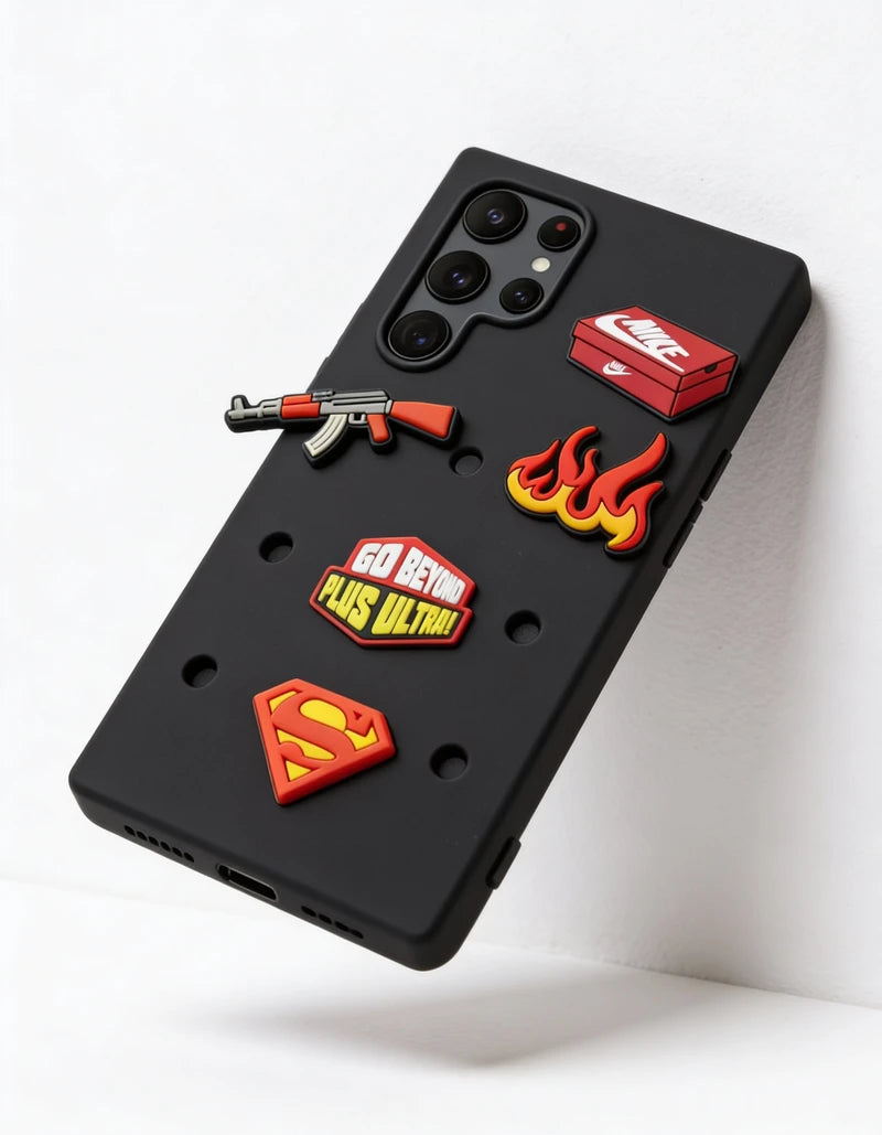 Black phone case with various stickers including a gun, fire, and superhero logo on a white background