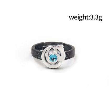 Ring with blue gemstone and black band on a white background, showing weight and diameter measurements.