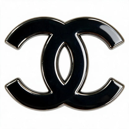 A glossy black interlocking CC logo charm with a polished silver-tone metal border, set against a plain white background.