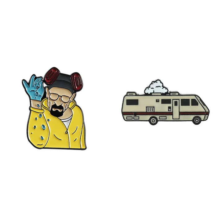 Two enamel pins on a white background, one resembling a character in a yellow jacket and the other a beige RV.
