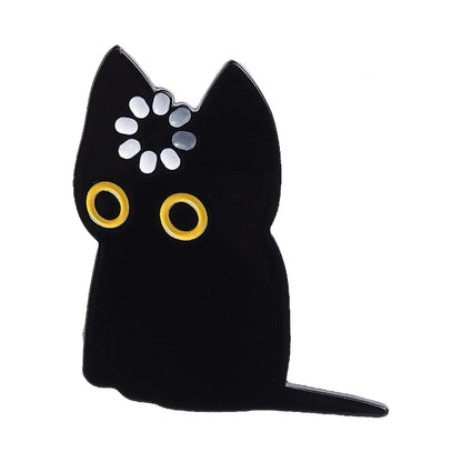 Black cat-shaped mirror with yellow eyes on a white background