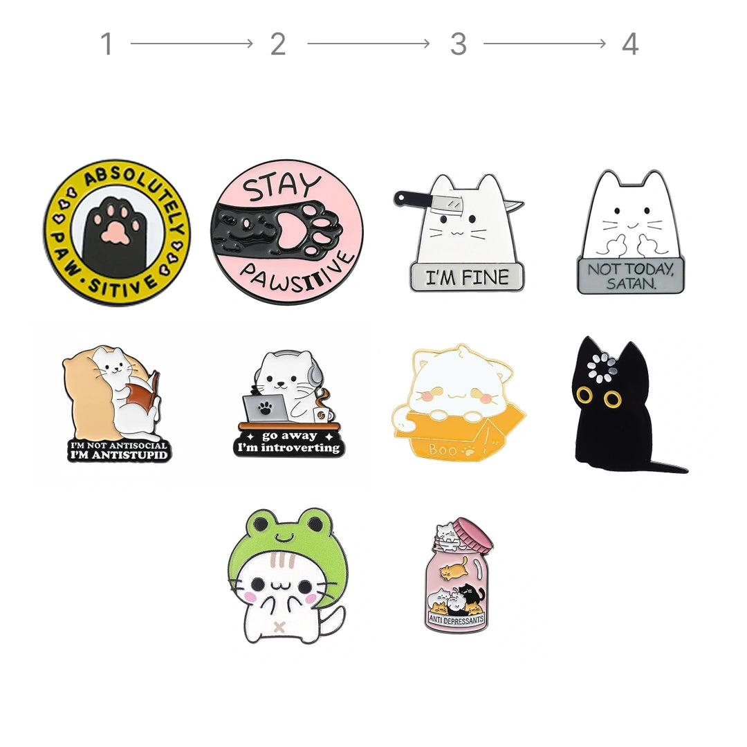 A set of cute cartoon cat enamel pins arranged on a plain white background, with a small numbered guide at the top suggesting how to assemble or view the pins. The pins feature various designs including a yellow paw print pin, a pink paw print pin, a white cat pin with a bowtie, a gray cat pin with a sign, a white cat pin reading 'I'M FINE', a black cat pin, a frog pin, and a jar pin.