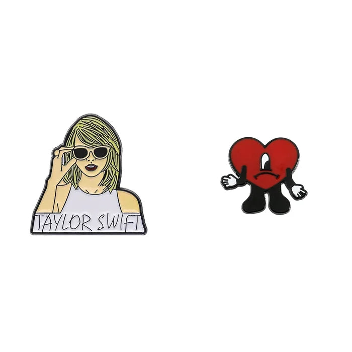 Two enamel pins on a white background, one featuring a person with sunglasses and the other a red heart character.