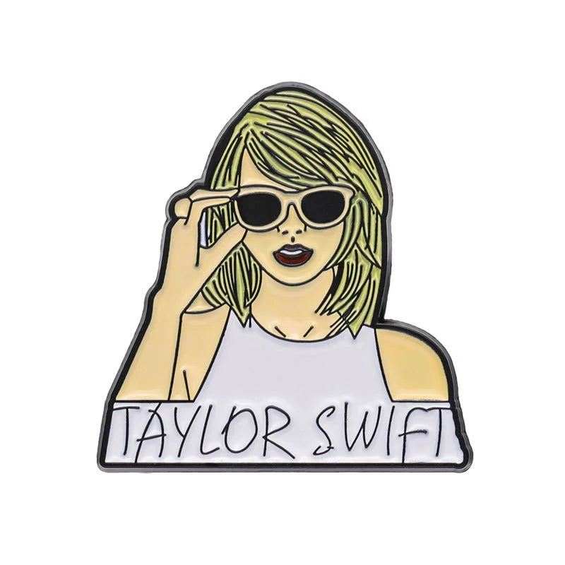 Enamel pin of a person wearing sunglasses with 'Taylor Swift' text on a white background