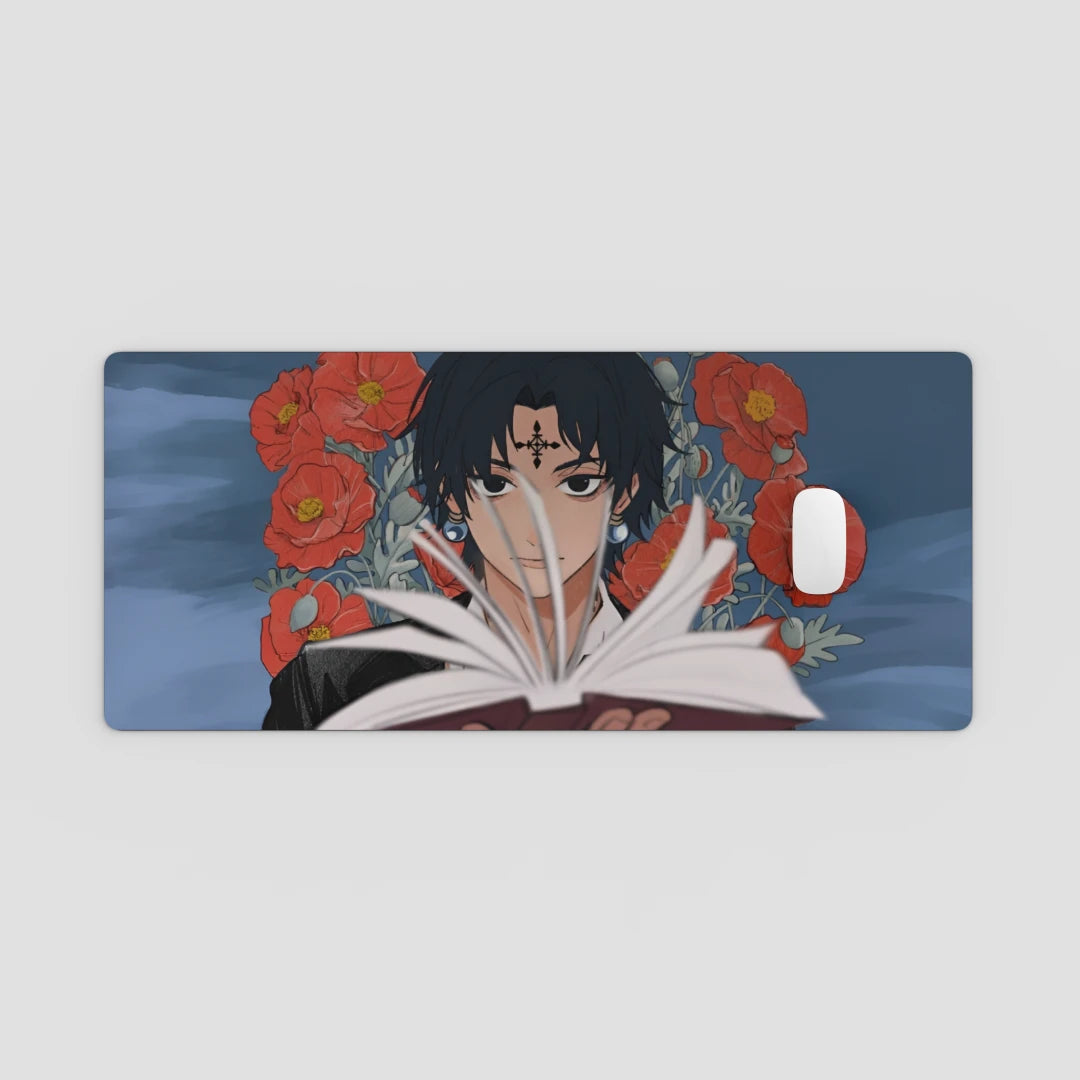 Desk Mat with anime character reading a book and red flowers on a blue background