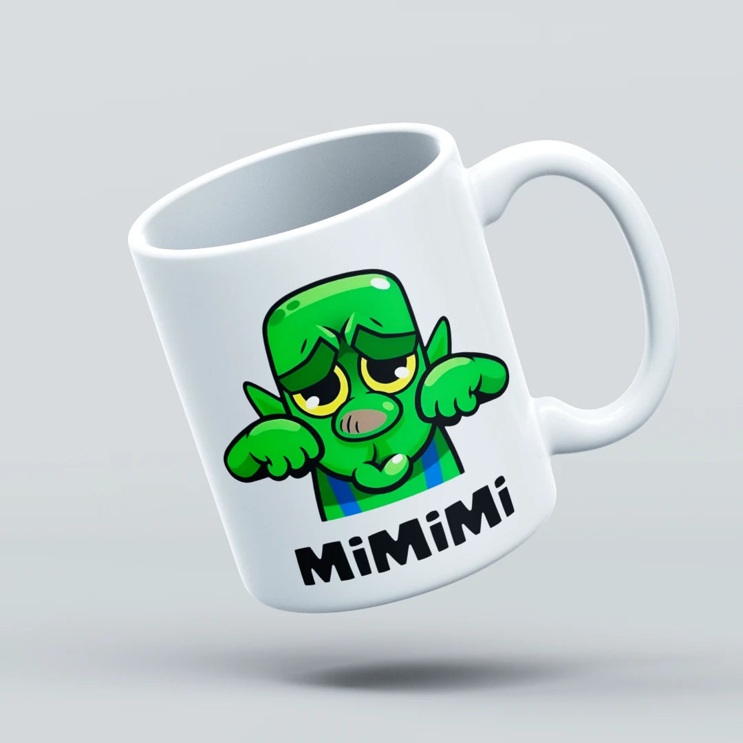 White mug with a green cartoon character and 'Mimimi' text on a light gray background