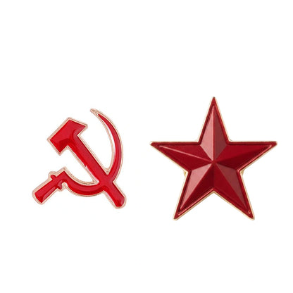 Two red enamel pins on a plain white background: a hammer and sickle on the left and a five-point star on the right, both outlined in gold-toned metal.