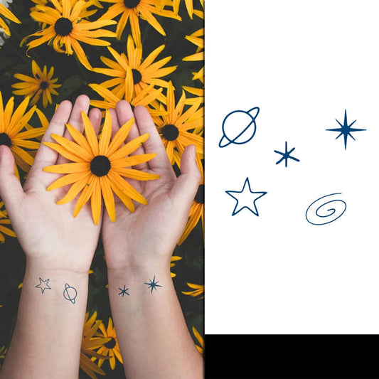 Two hands holding yellow flowers with star tattoos on a black background