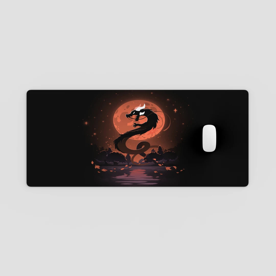 Dragon design on a black mouse pad with a red moon in the background