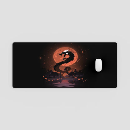 Dragon design on a black mouse pad with a red moon in the background
