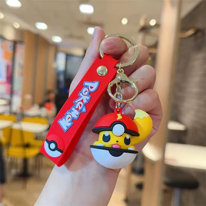 Keychain with cartoon character design held in a hand, blurred restaurant interior in the background