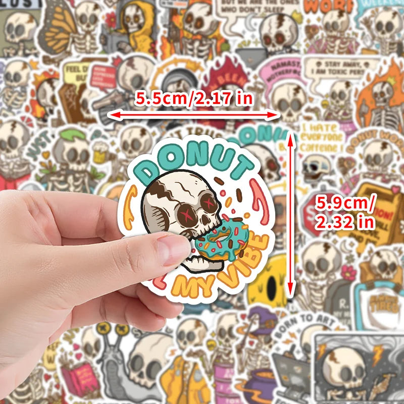 Hand holding a sticker with a skull eating a donut design, surrounded by various other stickers.