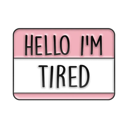 Name tag with text 'HELLO I'M TIRED' on a pink and white background
