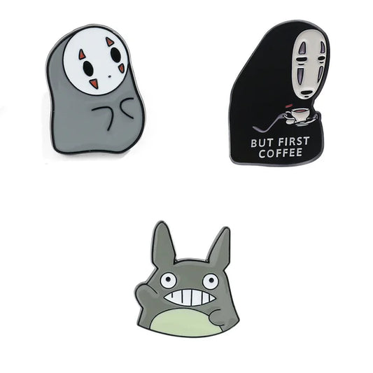 Three cartoon character pins on a white background