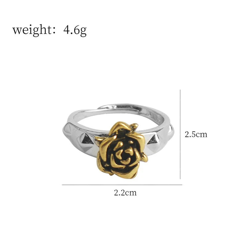 Ring with gold rose design and measurements on a white background