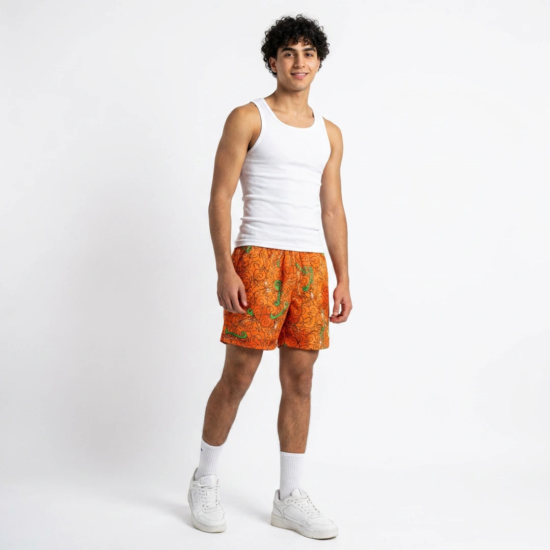 Person wearing a white tank top and orange patterned shorts on a white background