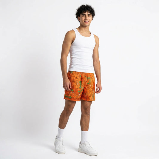 Person wearing a white tank top and orange patterned shorts on a white background
