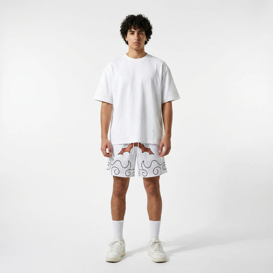 Person wearing a white t-shirt and shorts with a pattern on a plain background