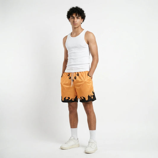 Person wearing a white tank top and orange shorts with black accents on a white background