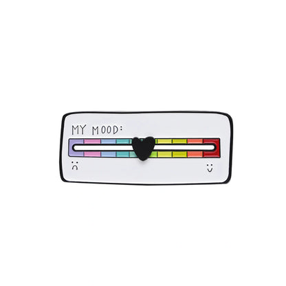 A white enamel pin shaped like a mood meter with a black border, featuring a colorful rainbow scale labeled 'MY MOOD:' and a black heart in the center.
