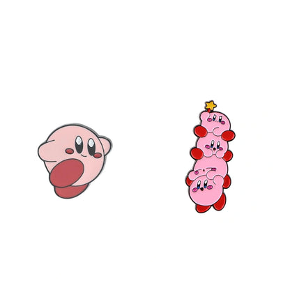 Two Kirby-themed enamel pins on a plain white background: one pin shows Kirby's face with its tongue sticking out, and the other shows a stacked, four-headed Kirby with a small yellow star on top.