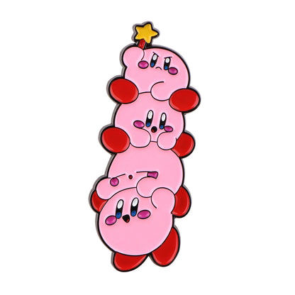 A vertical stack of four cartoon Kirby pins with a small yellow star on top, shown on a plain white background.