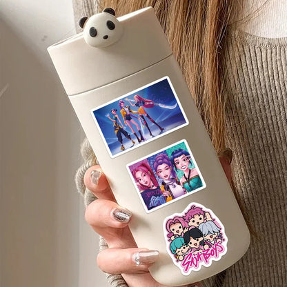 Hand holding a beige container with cartoon character stickers on a neutral background