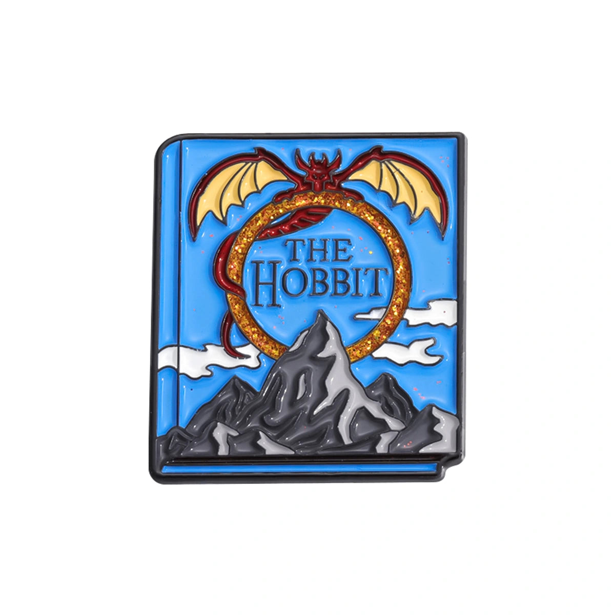 A square enamel pin depicting the cover of 'The Hobbit' book, featuring a blue sky, gray mountains, a red dragon, and a gold ring, on a plain white background.