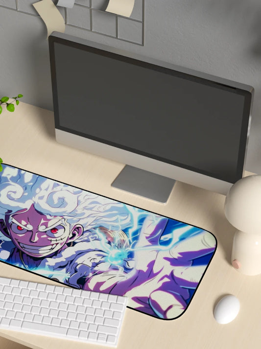 Desk setup with a computer monitor, keyboard, and mouse on a desk mat featuring anime character luffy in gear 5 form.