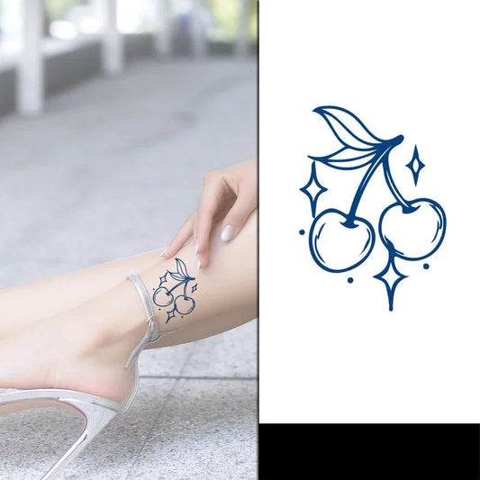 small cherries tattoo on females leg