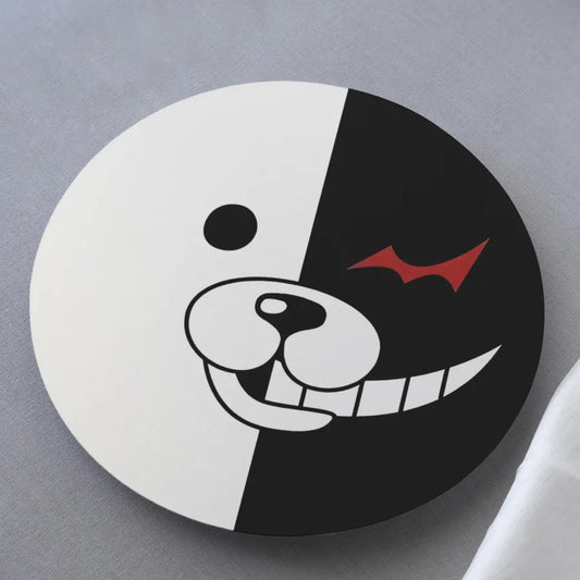 Round coaster with a black and white design featuring a snake and fish on a gray background