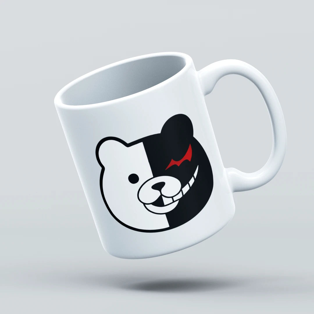 White mug with a black and white bear face design on a light gray background