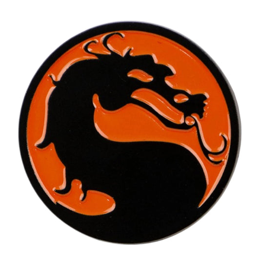 A circular black and orange enamel pin featuring the Mortal Kombat dragon logo, shown on a plain white background.