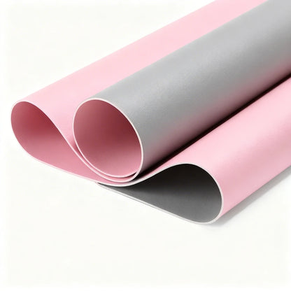 Two rolls of pink and gray vinyl on a white background