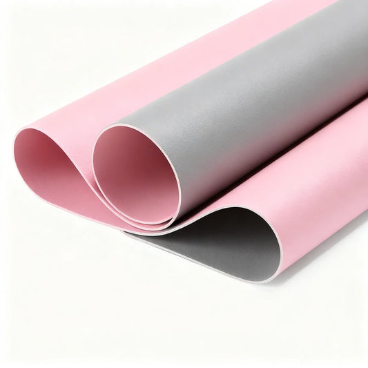 Two rolls of pink and gray vinyl on a white background