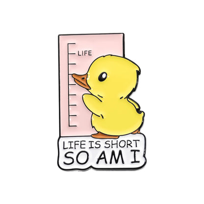 A cute enamel pin featuring a yellow duckling standing next to a pink height chart labeled 'LIFE' with the text 'LIFE IS SHORT SO AM I' on a white background.